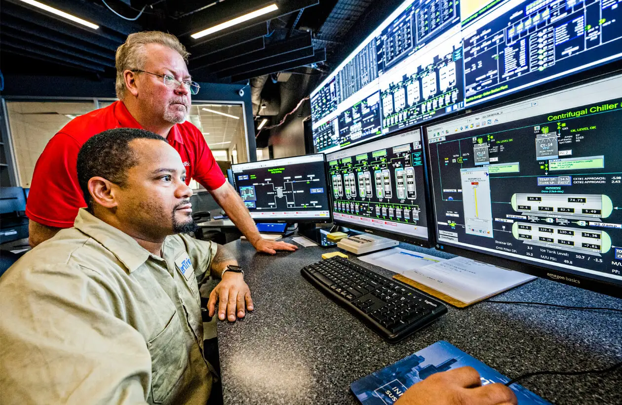 Two CenTrio operation team members working on several screens at our National Operations Center (NOC) at our Houston Rusk Plant.