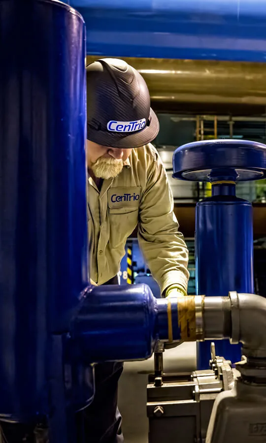 Photo of a Houston CenTrio Plant Operator performing maintenance on a piece of equipment.