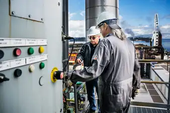 Two CenTrio Seattle operators on the roof of the plant working on equipment together