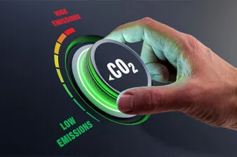 Lower CO2 emissions to limit global warming and climate change. Concept with manager hand turning knob to reduce levels of CO2. New technology to decarbonize industry, energy and transport