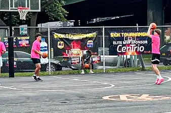 Community Basketball Tournament in Syracuse, NY with CenTrio Elite MVP Sponsor sign hanging on the fence in the background.