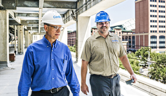 Two CenTrio plant operators walking side-by-side on the roof of our Houston Union Station Plant