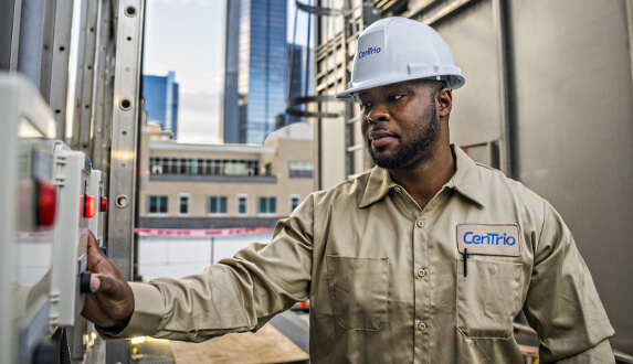 CenTrio plant operator standing in front of equipment on the roof of our Houston Union Station Plant