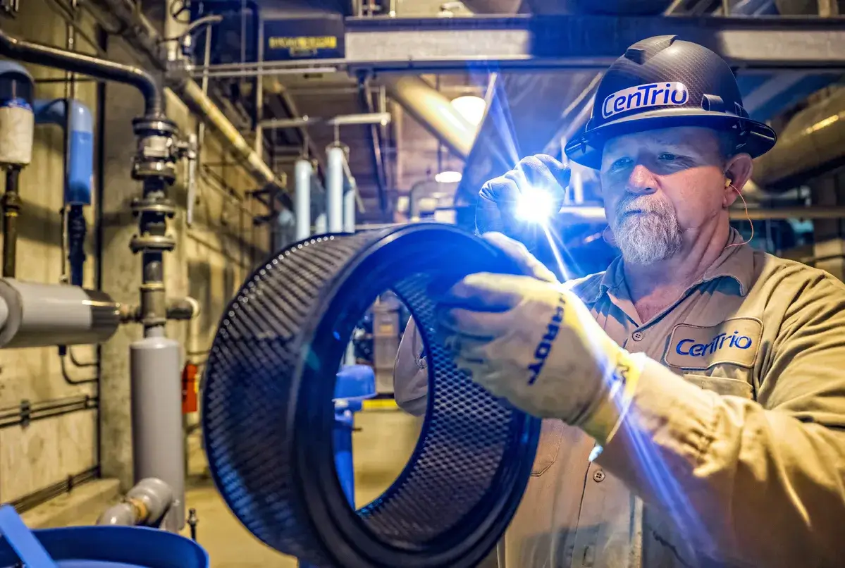 CenTrio operator in the plant performing routine maintenance on equipment.