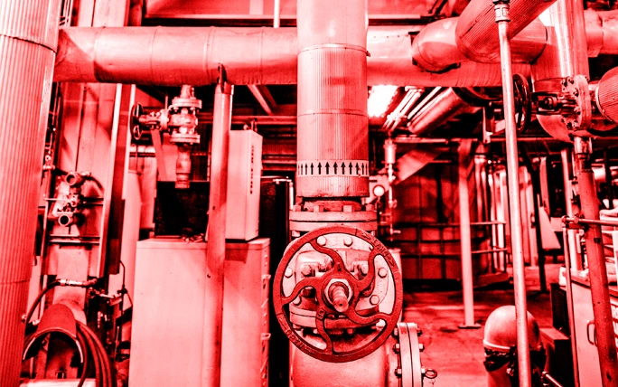 Red color overlay photo showing the inside of a CenTrio Heating Plant