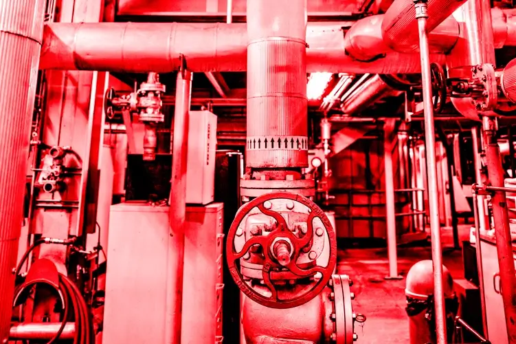 Red color overlay photo showing the inside of a CenTrio Heating Plant