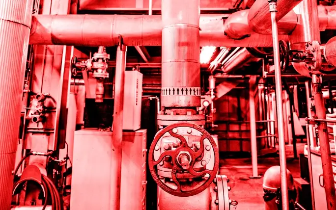 Red color overlay photo showing the inside of a CenTrio Heating Plant