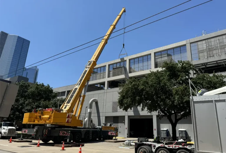 Large construction crane installing equipment on the roof of our CenTrio plant in Houston, TX.