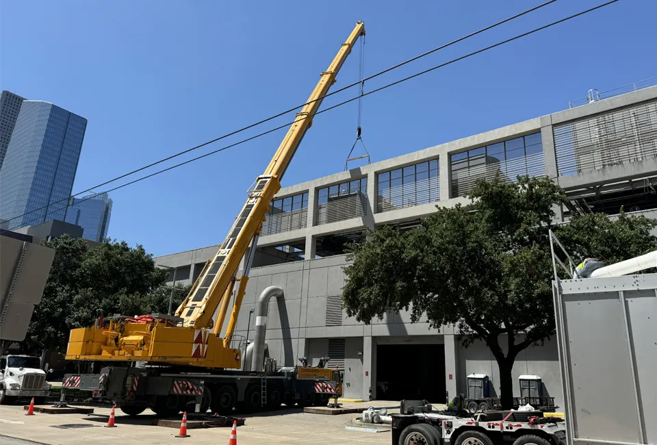 Large construction crane installing equipment on the roof of our CenTrio plant in Houston, TX.
