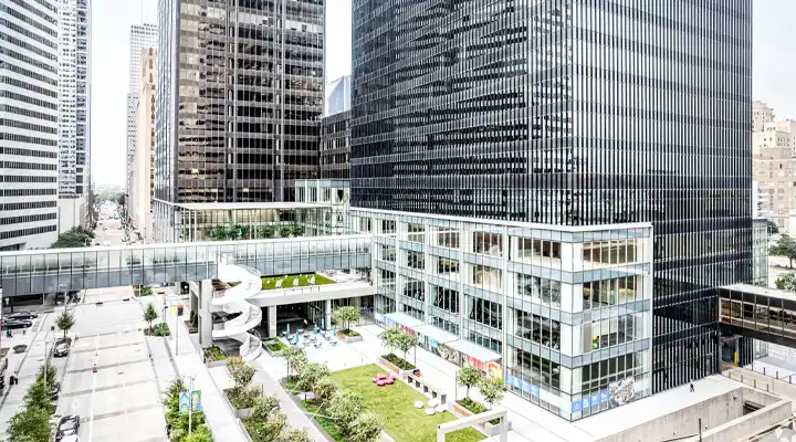 Aerial/street view of the Houston Center building, walking bridge and green space in downtown Houston