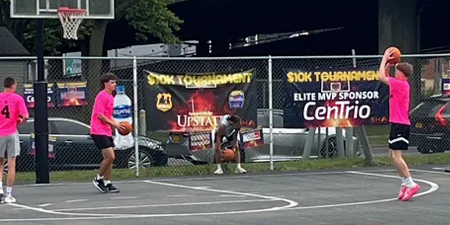 Photo from a basketball tournament in Syracuse, NY that CenTrio was an Elite MVP Sponsor that shows a teen shooting a baskeball.